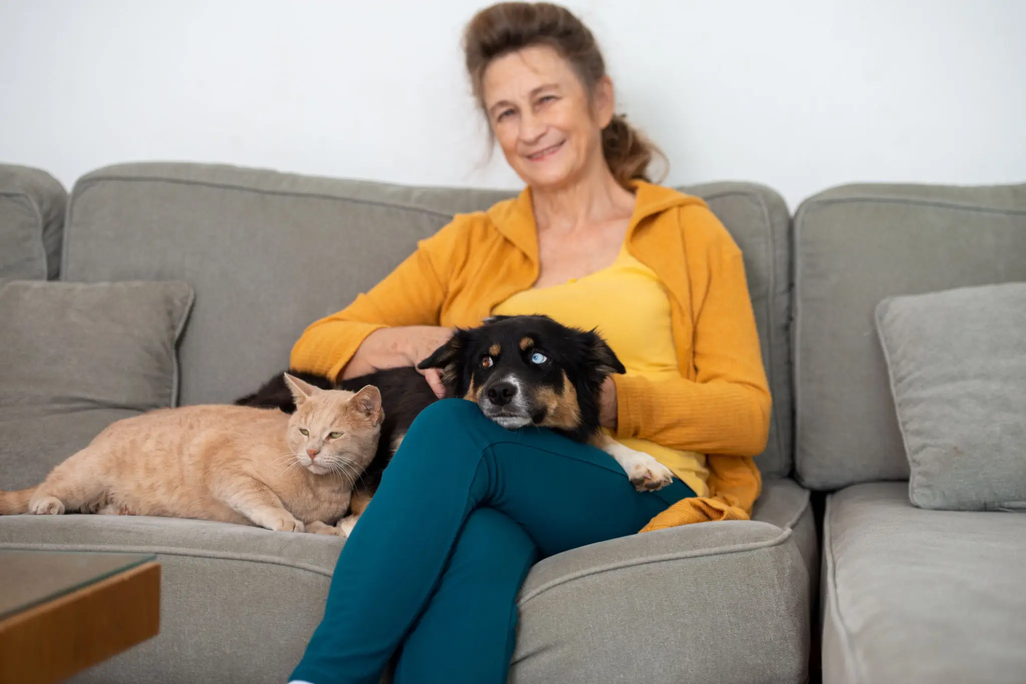 Woman with a cat and dog relaxing.