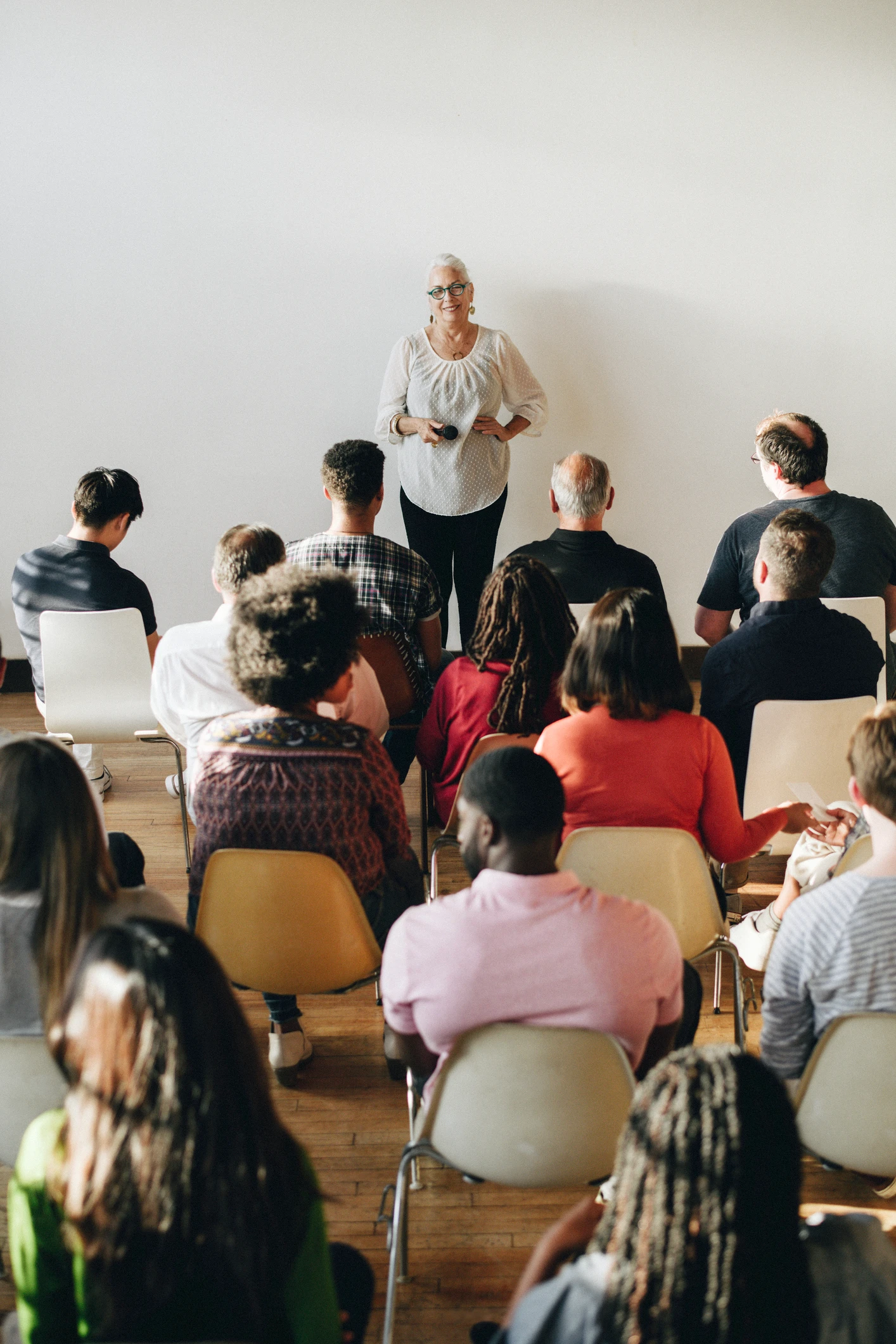 Audience listening to a speaker in classroom.
