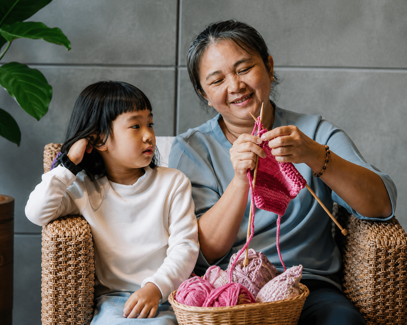 Family knitting together on cozy chair