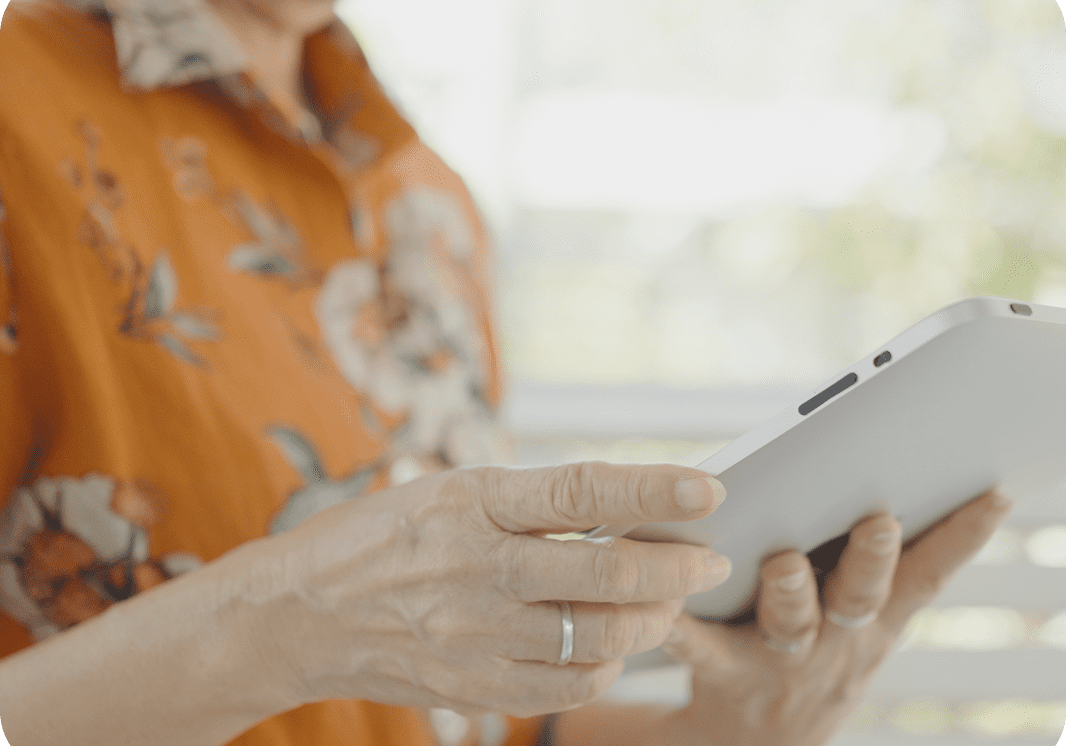Individual wearing floral shirt with tablet